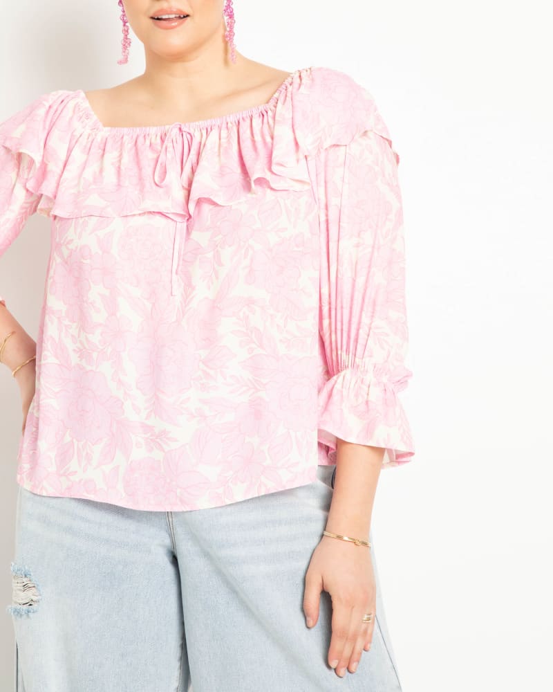 Front of a model wearing a size 18 Off The Shoulder Flounce Top in Dream Rose by ELOQUII. | dia_product_style_image_id:275208